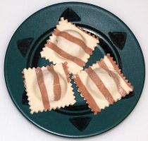 Striped dumplings filled with pitted prunes and dark chocolate